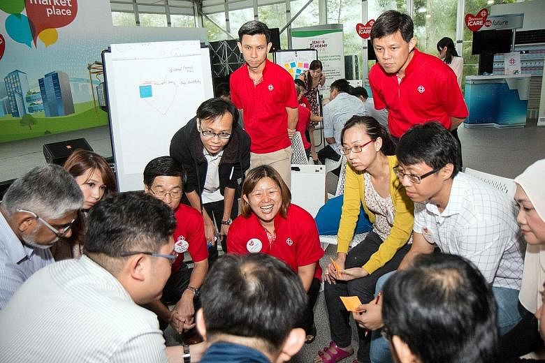 Minister in the Prime Minister's Office Chan Chun Sing (in red shirt, behind woman in yellow) at a session on Future Of Our Community in December, that was organised by the People's Association (PA). Mr Chan is also PA deputy chairman. Minister for C