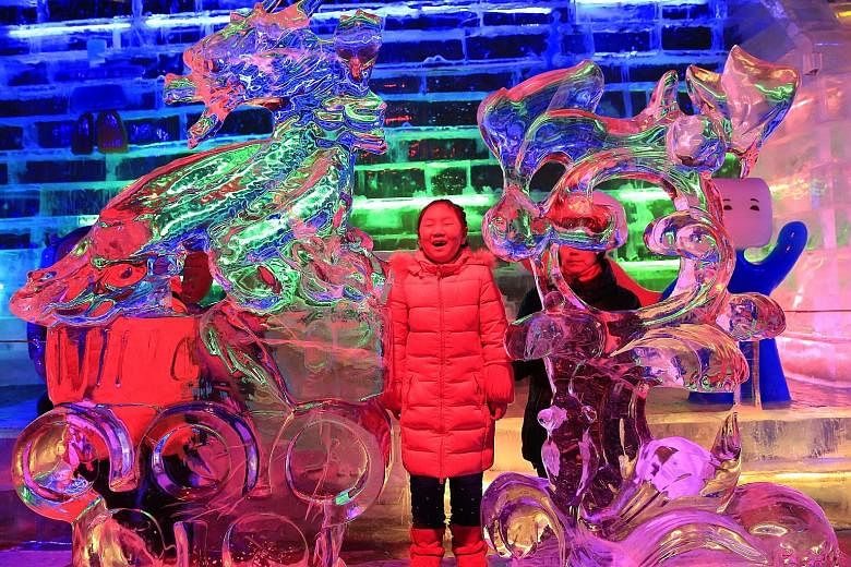 It was freezing but that did not stop this Chinese girl from venturing out of her home to enjoy these colourfully lighted ice sculptures at the Longqingxia Ice Lantern Festival in Yanqing district of Beijing on Saturday. People braved the cold and th