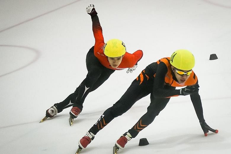 Lucas Ng of Singapore (left) attempting to overtake Wong De-vin of Malaysia at the Rink at JCube. He eventually won the 1,000m final to add to his 500m and 1,500m titles on Saturday.