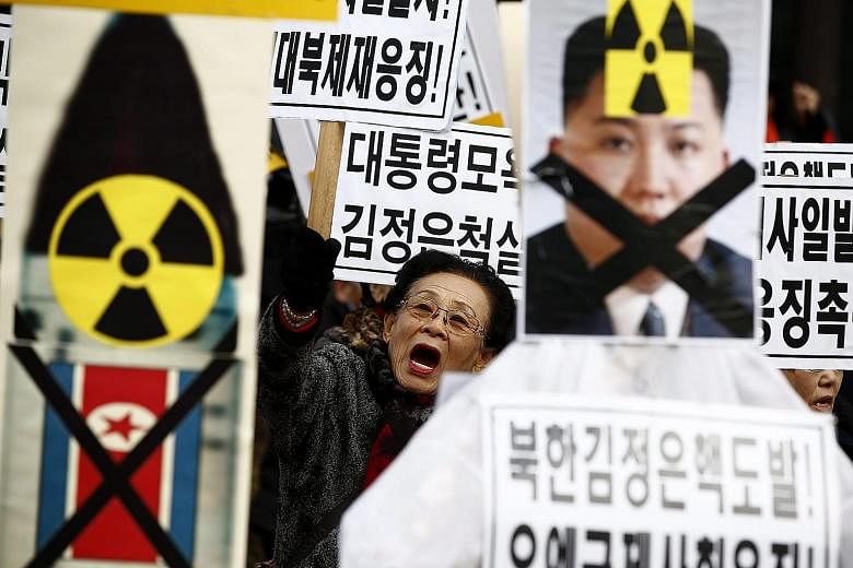 South Korean activists with placards and portraits of North Korean leader Kim Jong Un during a rally in Seoul earlier this month against his regime's long-range rocket and nuclear tests this year.