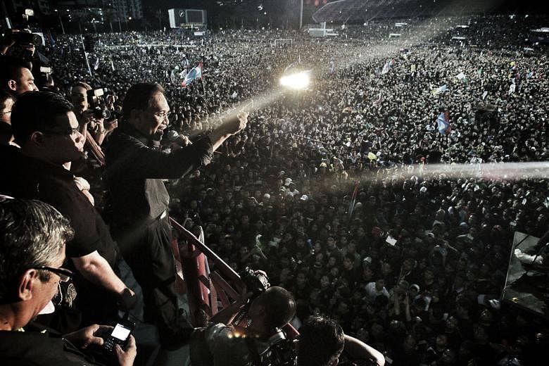 Malaysian opposition leader Anwar Ibrahim at a rally in Kelana Jaya, Selangor, after the general election in 2013. He is serving a five-year jail sentence but could be out in 31/2 years on good behaviour. However, he will be barred from contesting an elec
