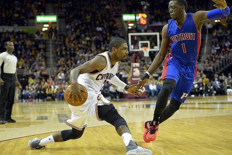 Cavaliers guard Kyrie Irving (left) dribbling against Pistons guard Reggie Jackson during the game on Monday night.