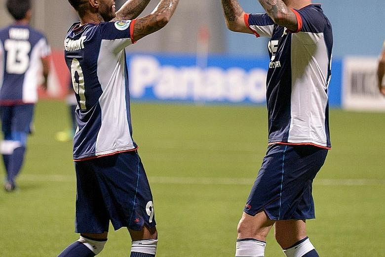 Jermaine Pennant (far left) and Billy Mehmet celebrating their opponents' own goal, which gave Tampines a commanding 4-0 lead. The Stags are aiming to make the knockout phase of the AFC Cup for the first time since 2011.