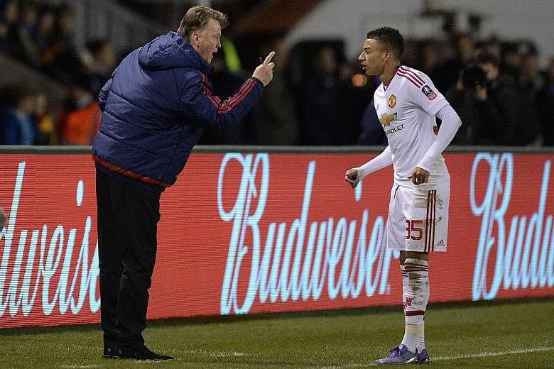 Manchester United manager Louis van Gaal gestures towards Jesse Lingard during their FA Cup fifth-round tie with Shrewsbury. The midfielder scored the third goal to help United to a 3-0 win and progress to the quarter-finals where they will face fell