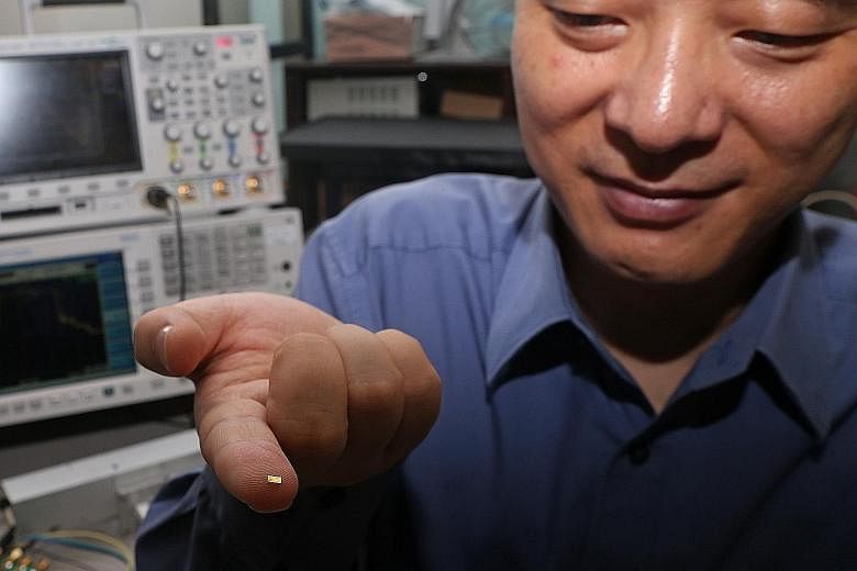 Prof Zheng from NTU's School of Electrical and Electronic Engineering with the new radar camera microchip on his fingertip. Despite its size, it can produce images twice as clear as conventional radar cameras.