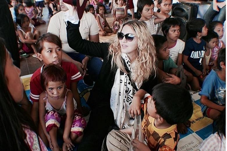 Madonna visiting Bahay Tuluyan, home to about 500 abused or abandoned children.