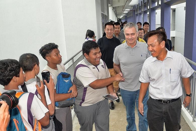 It was all smiles and handshakes yesterday as Martin Tan (extreme right), principal of Northlight School, ushered Jose Mourinho around, to the delight of students and staff.