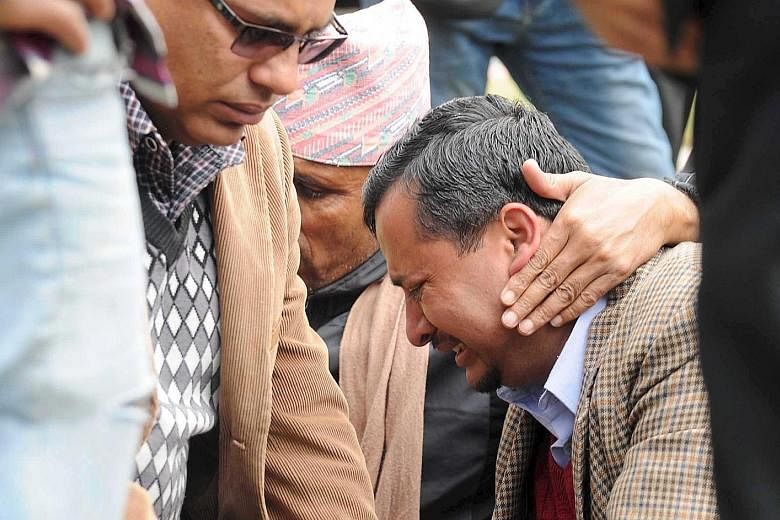 A family member in tears as he waited at the airport after a Tara Air plane crashed in bad weather in Pokhara, Nepal, yesterday. The cause of the crash was not known. A statement on Tara Air's website said weather conditions were good when the plane 