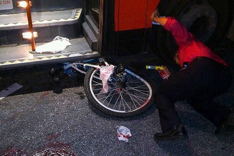 A handout picture taken by the victim's aunt showing the boy's bicycle pinned under the bus. He was riding across the zebra crossing on Choa Chu Kang North 5 when he was knocked down by an SMRT bus and dragged for about 10m. His left foot, which was 