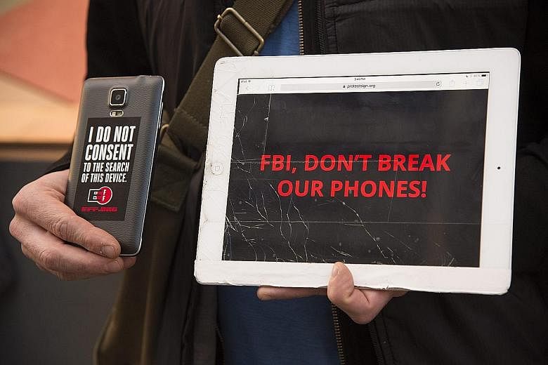 A protest in front of an Apple Store in San Francisco on Tuesday. Apple says law enforcement agencies nationwide "have hundreds of iPhones they want Apple to unlock" if the FBI wins the San Bernardino case.
