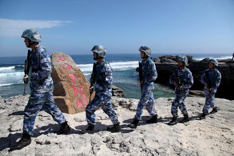 China's soldiers on Woody Island in the Paracel archipelago - which the Chinese call the Xisha islands - last month. Beijing's reported deployment last week of a surface-to- air-missile system to the Paracel islands coincided with the conclusion of a summ