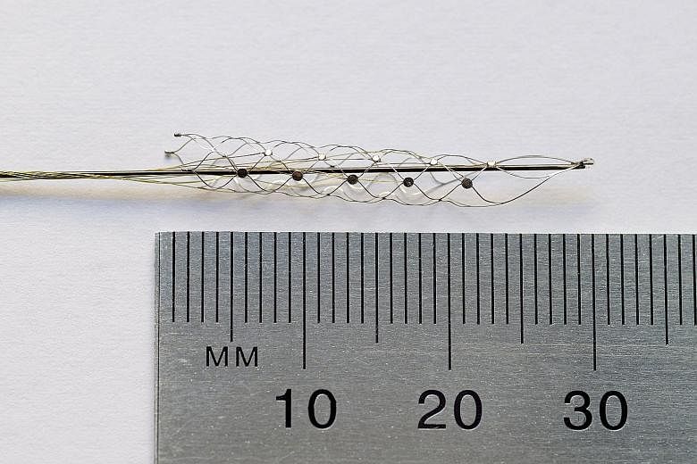 Above: A matchstick-size stentrode in a handout photo from the University of Melbourne. This bionic spine also enters human trials next year and promises the ability to move bionic limbs with thoughts. Left: Assistant Professor Arindam Basu from NTU 