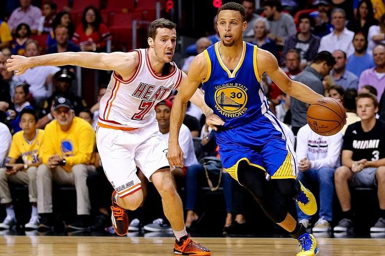 Stephen Curry of the Golden State Warriors dribbling past Goran Dragic of the Miami Heat during the game at the AmericanAirlines Arena. He finished with 42 points, seven assists and seven rebounds to help the Warriors to a 118-112 victory, which also