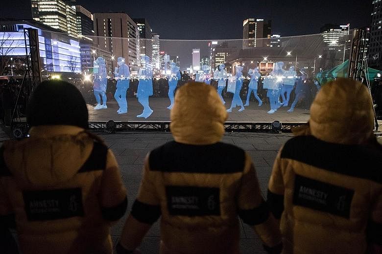 A screen displaying "ghost protesters" during a rally by Amnesty International in support of freedom of assembly and expression in South Korea. The human rights group pushed ahead with the "Ghost Protest" after police threatened a crackdown on the vi