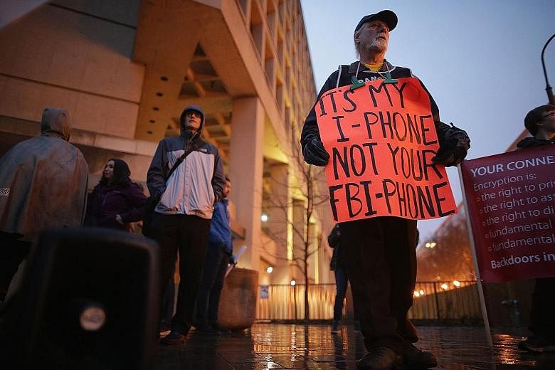 Protesters outside the FBI headquarters in Washington DC on Tuesday. Apple says it is only protecting the privacy of its customers.