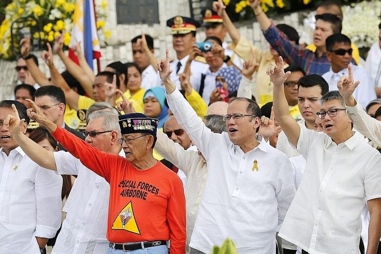 Philippine President Benigno Aquino (second from right) and former president Fidel Ramos (second from left) led the celebration at the People Power monument in Quezon city yesterday to mark the 30th anniversary of the fall of dictator Ferdinand Marco