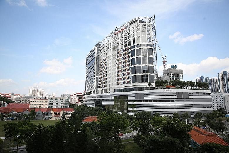 The new Farrer Park Hospital (left) has an adjoining hotel, which can serve as an alternative place for patients to recuperate. Chief executive Timothy Low (above) says Singaporeans will make up half of its patients.