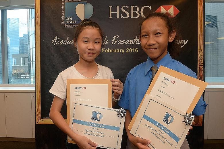 Shanice Ng (far left) and Ain Nabihah, both 13, were among 10 beneficiaries of The Straits Times School Pocket Money Fund who were rewarded for their high PSLE scores with a cash prize from HSBC.