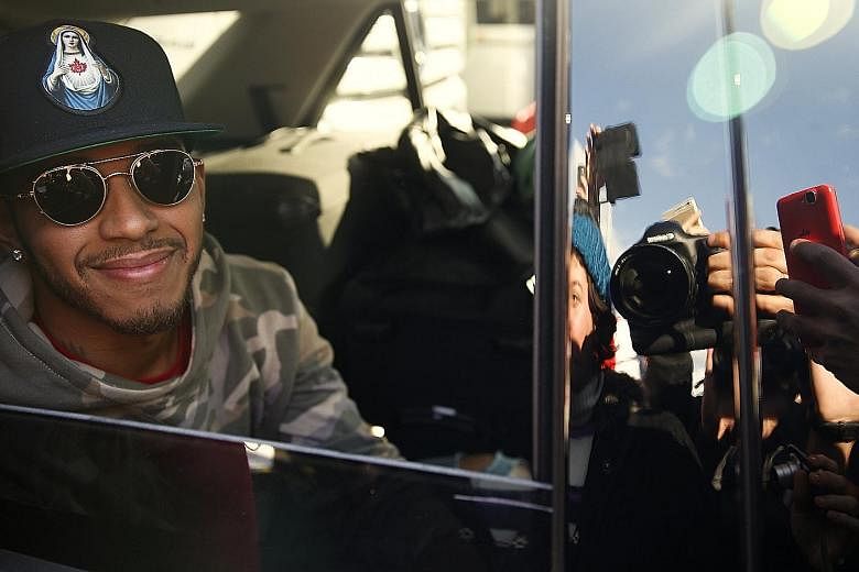 Lewis Hamilton posing for photos as he leaves Spain's Circuit de Catalunya yesterday. The triple F1 world champion completed 342 laps totalling 1,592km for the first pre-season test.