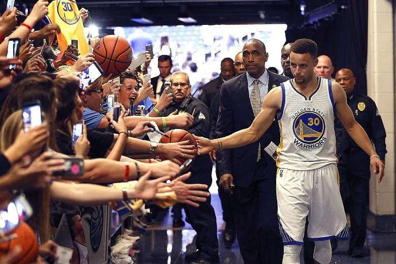 Warriors guard Stephen Curry thanking fans in the tunnel after Golden State's 130-114 victory over Orlando at Amway Centre. They need 21 wins from their final 25 games to beat the regular-season record of 72 wins set by the Chicago Bulls in 1996-97.
