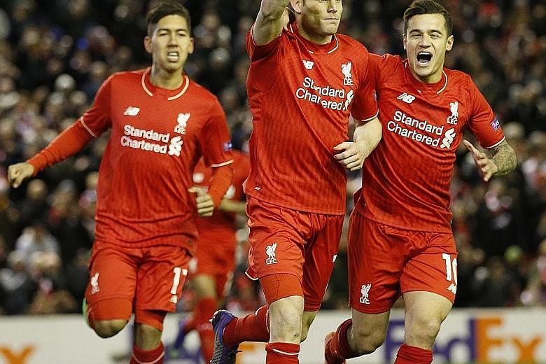 James Milner (centre) celebrating with Roberto Firmino (left) and Philippe Coutinho after netting his spot-kick against Augsburg. The only goal over two legs took the Reds into the Europa League last 16, where they were drawn against long-time rivals