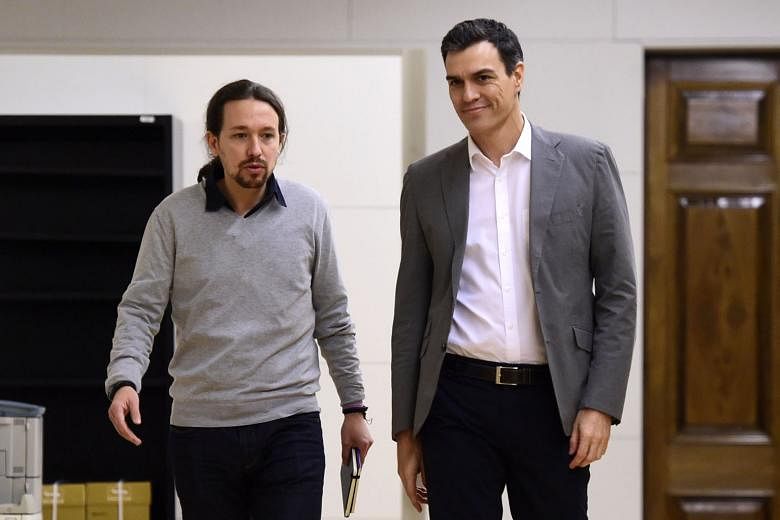 Spanish Socialist party leader Pedro Sanchez (right) and anti-austerity party Podemos leader Pablo Iglesias arriving for a meeting at the Spanish Parliament in Madrid on Feb 5.PHOTO: AGENCE FRANCE-PRESSE