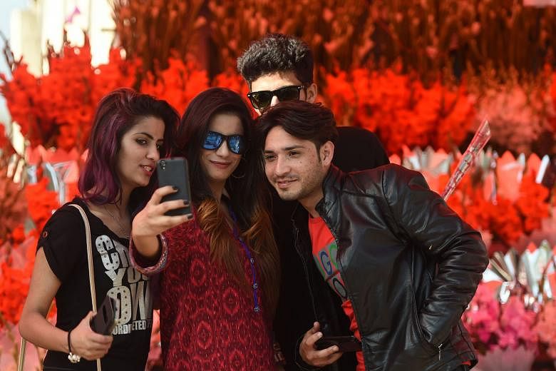 Young people in Islamabad taking a wefie. Strict religious and familial controls still dictate behaviour for many in Pakistan. 