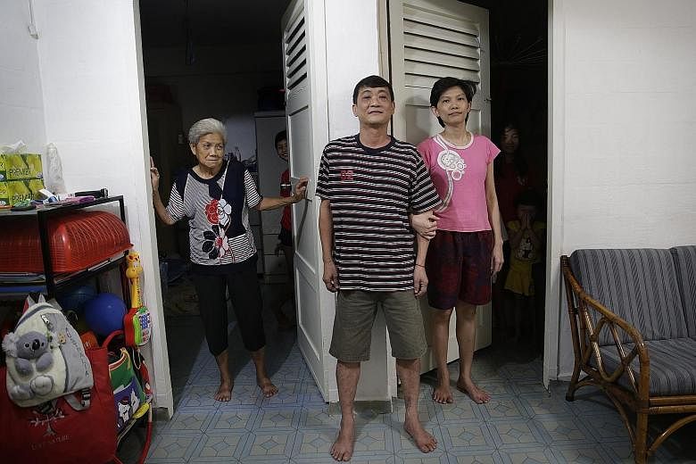 Mr Ong with his mother Ng Tang Neo, 72, and wife Chew Bee Lee, 36, and their three daughters. He puts in long hours as a cooked food stall assistant to make ends meet, working from around 7am till nearly 9pm.