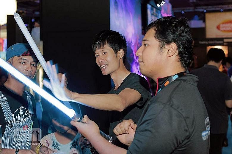 Mr Chen demonstrating his duel-ready, heavy-duty lightsabers at a roadshow last November.