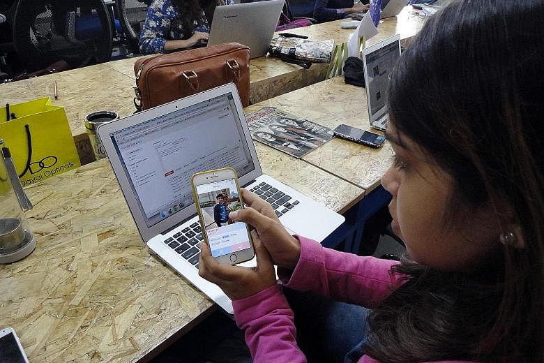 A member of the TrulyMadly staff in New Delhi demonstrating how her company's dating app works on the smartphone.