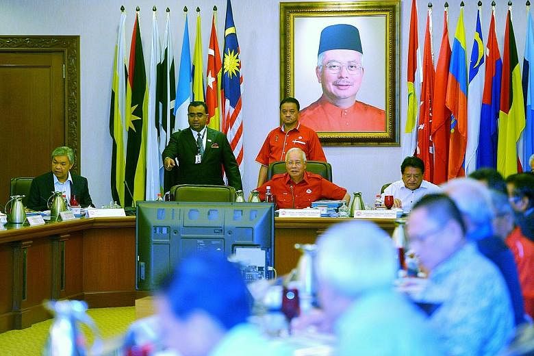 Mr Najib at an Umno meeting, with the seat on his right usually taken up by Mr Muhyiddin visibly empty on Friday.