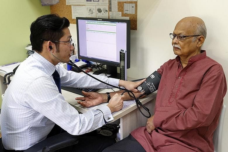 Dr Gilbert Yeo attending to Mr Sreedharan, who has diabetes and heart conditions. Mr Sreedharan has been visiting Ang Mo Kio FMC since September 2013 and appreciates the clinic's personalised approach.