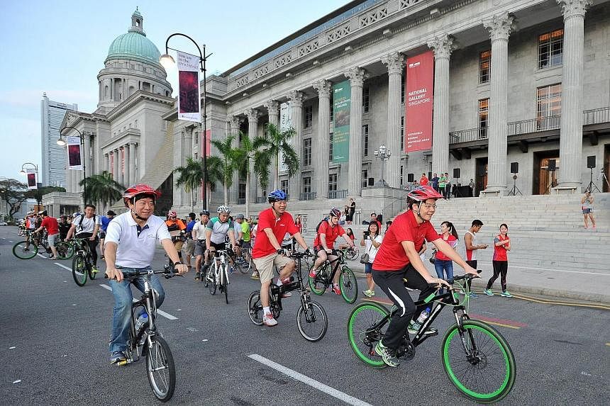Left: Cycling past the National Gallery Singapore along St Andrew's Road are Coordinating Minister for Infrastructure and Minister for Transport Khaw Boon Wan (left) and Mr Lawrence Wong (right).