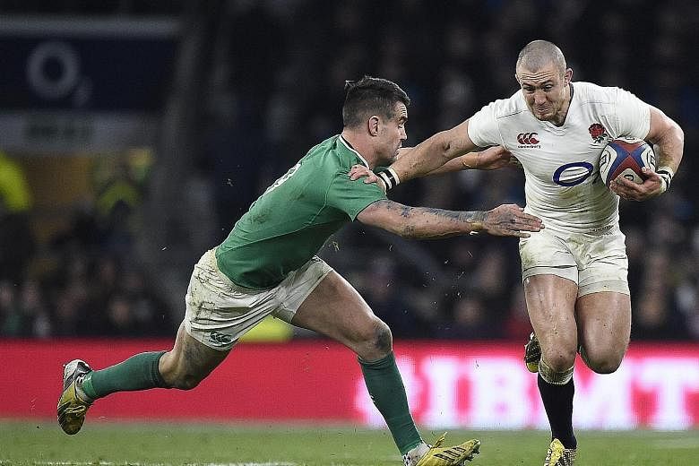 England's Mike Brown (right) being tackled by Ireland's Conor Murray during their Six Nations encounter on Saturday. England won comprehensively to move closer to a Six Nations clean sweep.