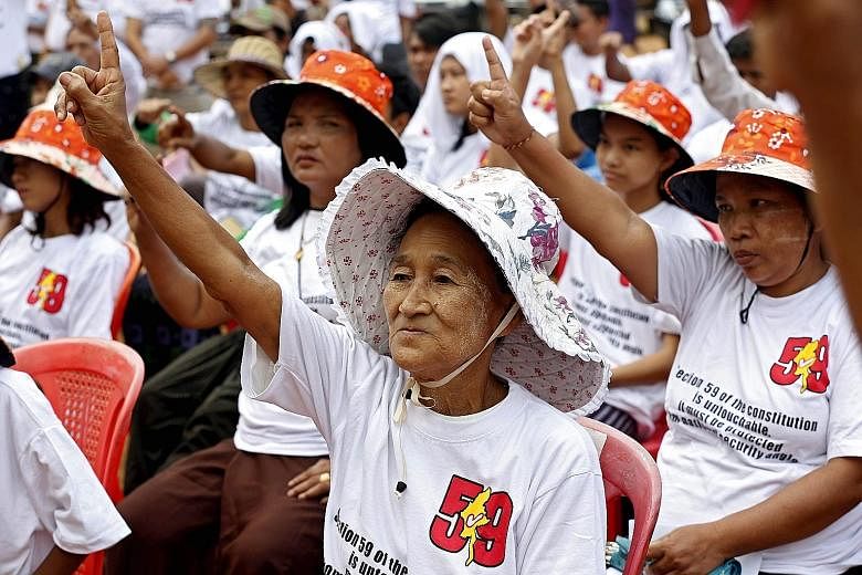 Hundreds of demonstrators in Yangon on Sunday protesting against tweaking Myanmar's Constitution to allow Ms Suu Kyi to become the next head of state.