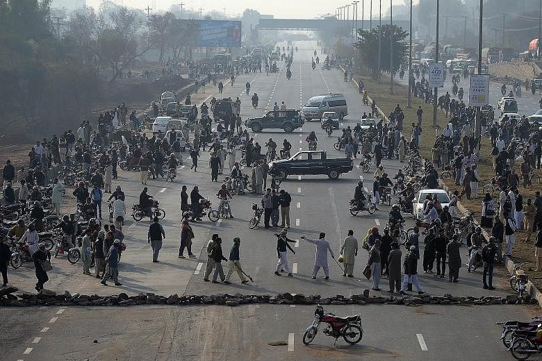 Supporters of Qadri blocking a highway in Islamabad during a protest against his execution yesterday. Qadri shot Punjab governor Salman Taseer 28 times in Islamabad in 2011 as the latter had championed the cause of a Christian woman sentenced to deat