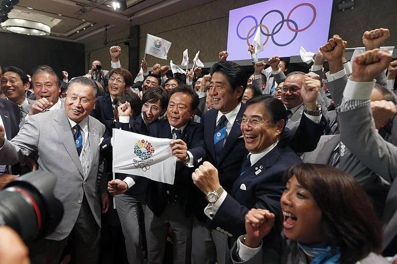Japanese Prime Minister Shinzo Abe celebrating with members of the Tokyo bid committee after the Japanese capital was announced by the International Olympic Committee as the host of the 2020 Olympic Games.