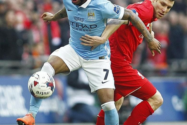 Manchester City's Raheem Sterling (far left) tussling with Liverpool's James Milner during the League Cup final