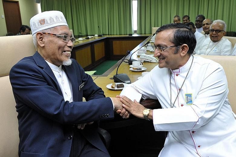 Penang's Mufti, Datuk Dr Wan Salim Mohd Noor (in white cap), and the Roman Catholic leader, Bishop Sebastian Francis, during their dialogue this week.