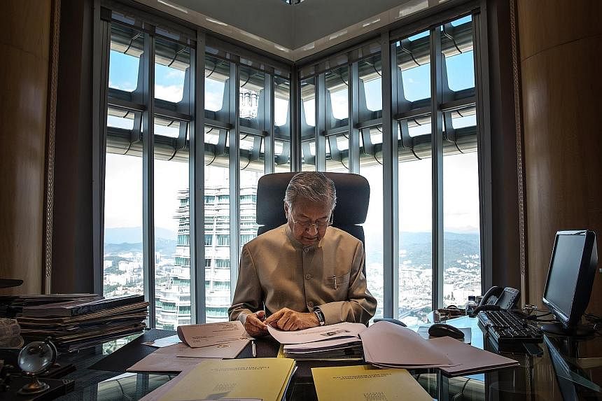 Dr Mahathir Mohamad working at his office in Kuala Lumpur last week. The former prime minister quit Umno on Monday, saying it has become "Najib's party".