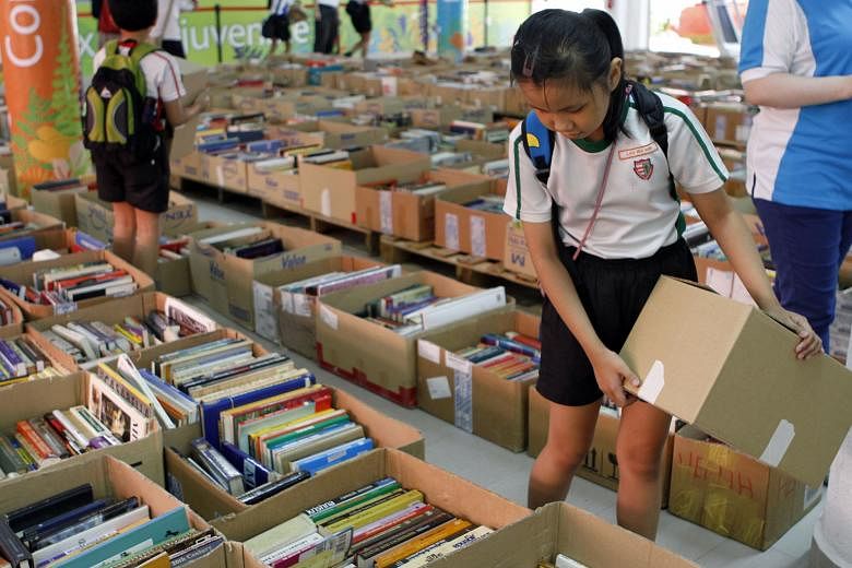 Schoolchildren browsing at the book carnival organised by the All Saints Home. The four-day event raised almost $30,000, including donations for four nursing homes. 