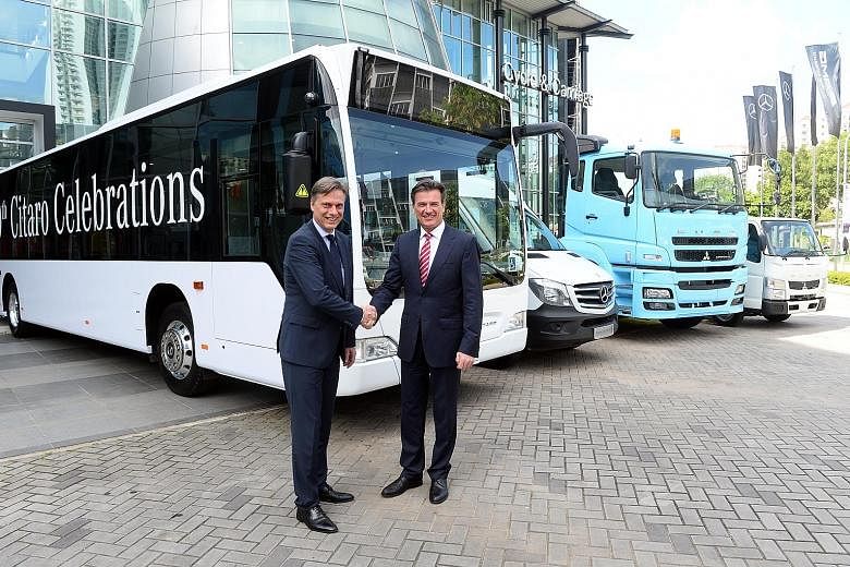 Mr Ahlden (left), head of Daimler's regional centre for commercial vehicles in Singapore, with Mr Bernhard, a member of the automotive giant's board.