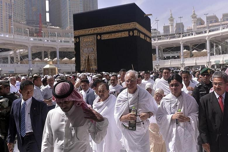 Malaysian Prime Minister Najib Razak and his wife, Datin Seri Rosmah Mansor (behind him, to his left), leaving after circling Islam's holiest shrine, the Kaabah, in Mecca yesterday. They were performing the umrah (mini haj) ritual during his visit to