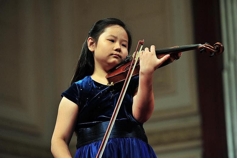 Susan Tang (left) has performed the Butterfly Lovers Violin Concerto with her father, Chinese conductor Tang Muhai (below), more than 10 times.