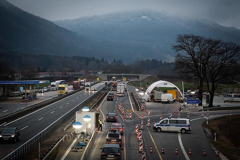 German police checking a cargo van along a motorway on the border with Austria.