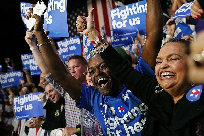 Supporters of Mrs Hillary Clinton at her Super Tuesday gathering in Miami, Florida. Many Democratic voters said they were ready to eschew the dreamy Bernie Sanders revolution for Mrs Clinton as they believe she can save them from a Trump presidency.