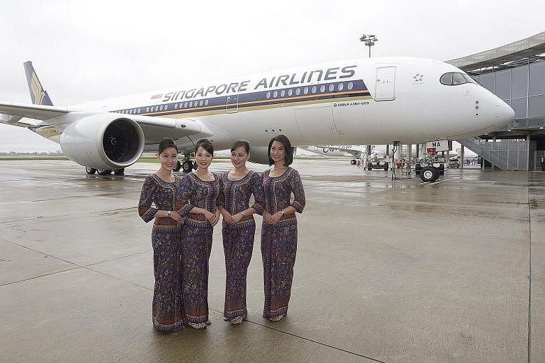 (From left) Singapore Girls Celeste Xu, Ashlyn Ong, Jasmine Sie and Sarah Khairul Anuar in front of Singapore Airlines' new A350-900 at the Airbus Delivery Centre in Toulouse yesterday. The long-haul jetliner is scheduled to arrive at Changi Airport 