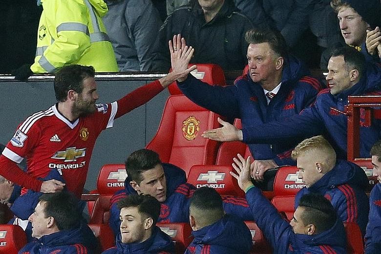 Manchester United's Juan Mata (far left) celebrating with Louis van Gaal and Ryan Giggs after being substituted in the 1-0 win over Watford, where he scored the winner.
