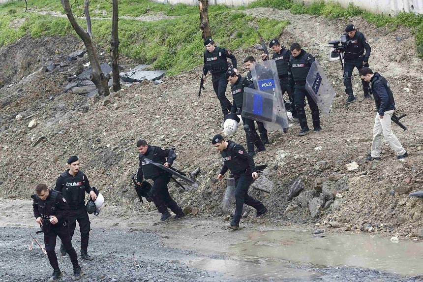 Special forces officers conducting a search operation following the attack at the entrance to a police station in the Istanbul suburb of Bayrampasa, Turkey, yesterday.