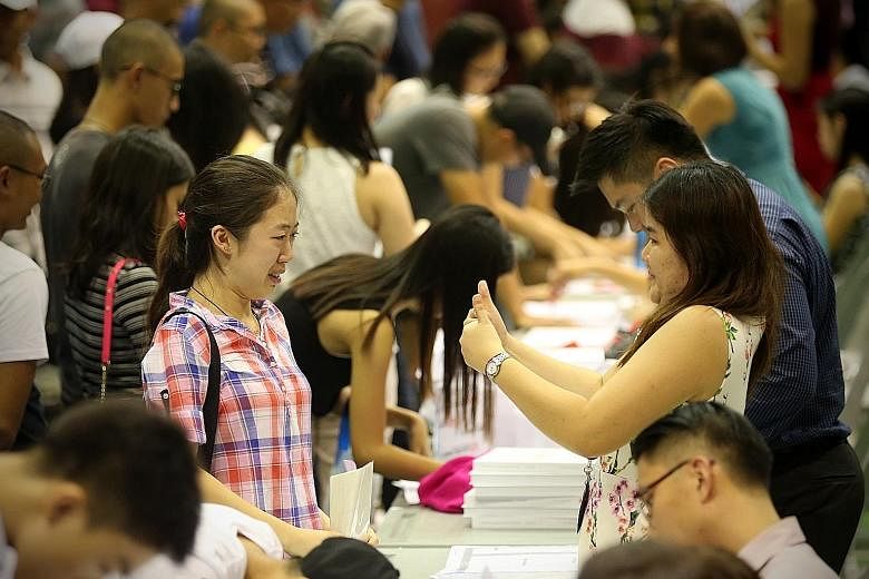 Student Crystal Sia (left), 18, getting the thumbs up yesterday from her Hwa Chong Institution civics tutor Violet Teo for her good results.